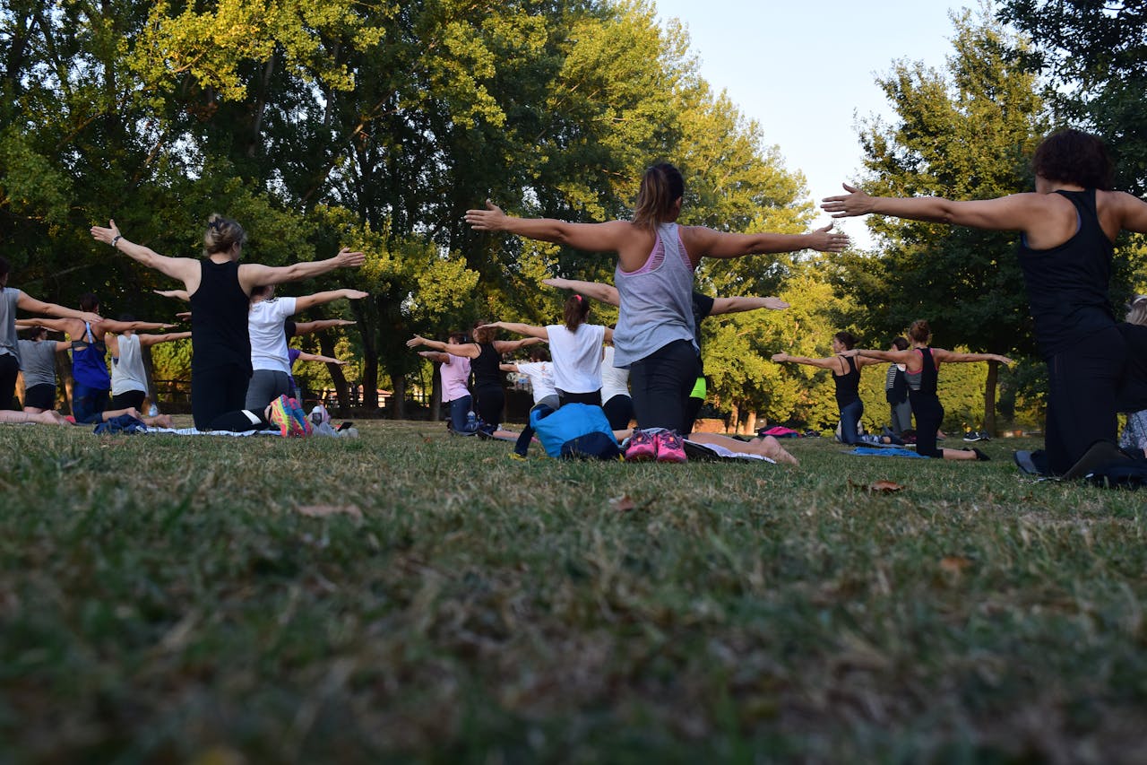 Group of people outdoors doing yoga