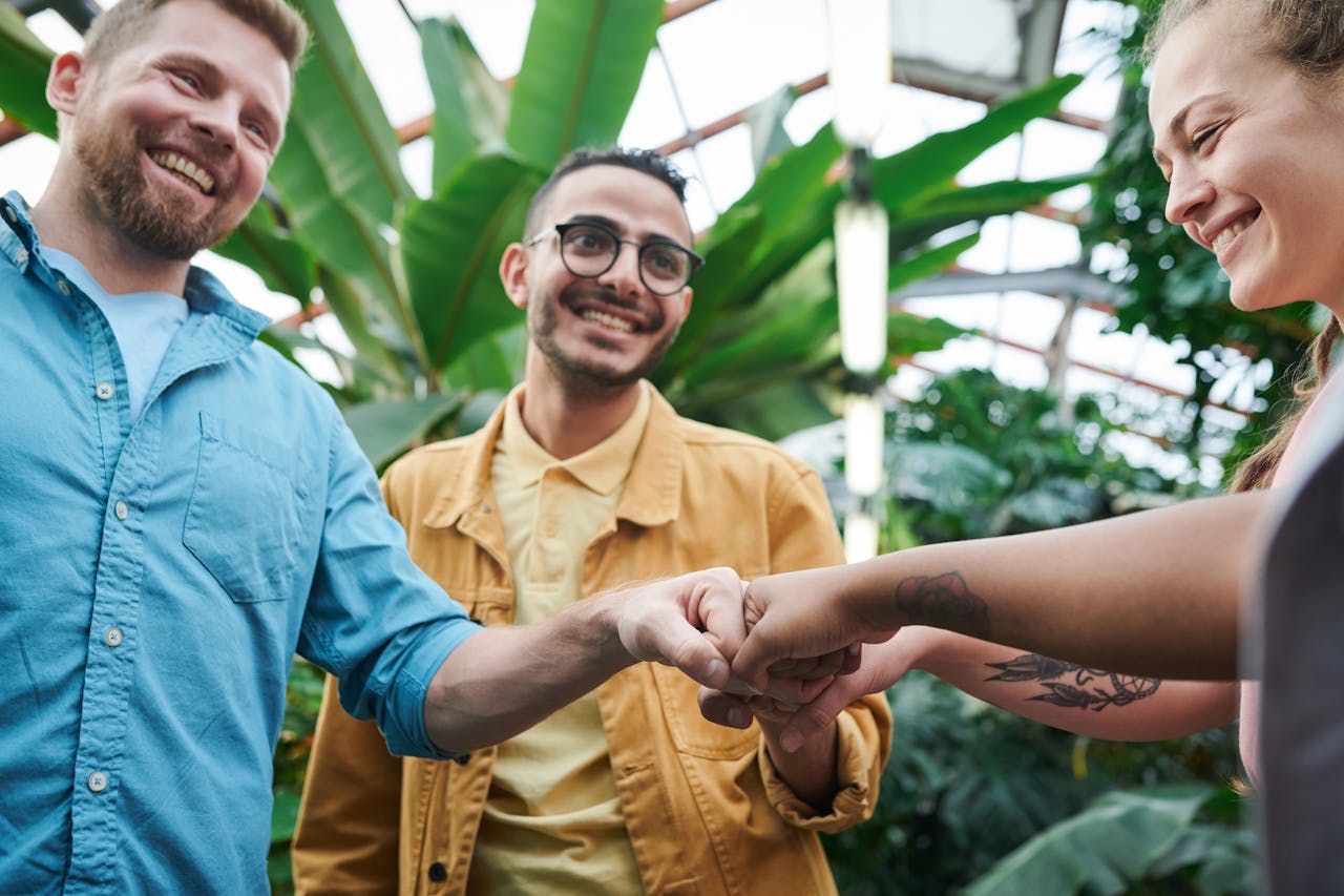A group of people connecting, fist bumping